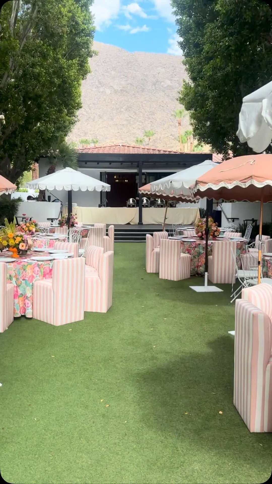 An outdoor Palm Springs event setup with mountain views, styled for a Well Company client event